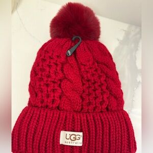 Ugg new red Pom Pom hat made of cotton & nylon.